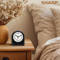 Sharp Battery-Powered Analog Alarm Clock, Silent Sweep, Snooze and Light | Silent no-tick movement; Ascending beep alarm; Gentle wake; Snooze; On-demand light; Compact size; Battery operated; Black